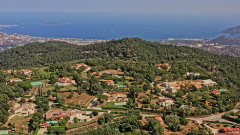 Tanneron-France-Aerial-v26-drone-flyover-villages-in-les-plaines,-reveals-beautiful-mountain-valley-with-pleasant-mediterranean-sea-in-the-background---July-2021