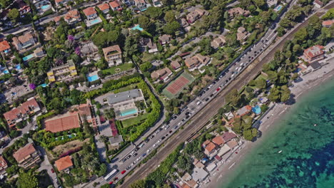 Eze-France-Aerial-v26-vertical-straight-down-view-capturing-waterfront-hillside-housing-neighborhood,-tilt-up-reveals-rocky-mountain-cliffs---July-2021