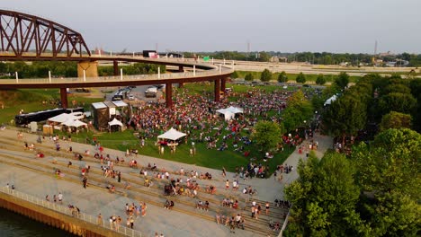 Aerial-drone-view-over-people-at-a-open-air-festival,-in-sunny-Louisville,-USA
