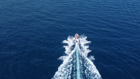Drone-Shot-Following-Pleasure-Yacht-in-the-Blue-Sea,-High-Angle