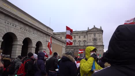 People-waving-Austrian-flag-at-anti-corona-protests-in-Vienna---Slow-Motion