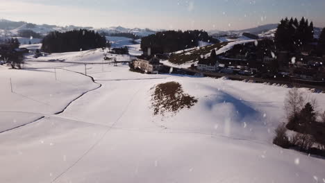 Beautiful-Switzerland-town-during-heavy-snowfall,-aerial-ascend-view