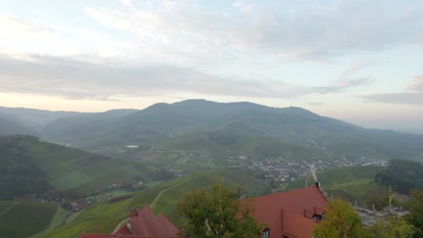 Fly-over-Staufenbergcastle-and-reveal-scenic-town-Durbach-with-its-vineyards