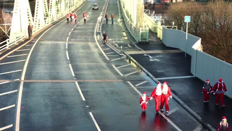 Charity-Santa-dash-fun-run-over-Runcorn-Silver-Jubilee-bridge-Aerial-view-hover-low-shot