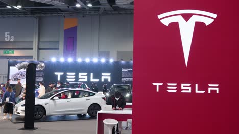 The-American-electric-company-car-Tesla-Motors-logo-and-booth-during-the-International-Motor-Expo-showcasing-EV-electric-cars-catalog-in-Hong-Kong