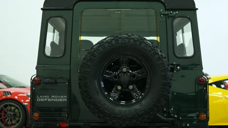 rear-wheel-of-land-rover-defender-classic-moss-green-110,-british-old-safari-wagon