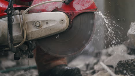 Close-Up-Of-A-Portable-Handheld-Cut-off-Saw-With-Water-Spray-From-Rotating-Blade