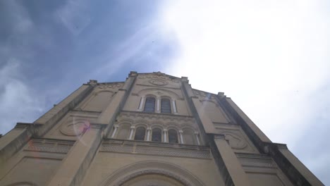 Entrance-of-Cathedral-of-St-Théodorit-on-sunny-day,-Tilt-down-reveal-shot