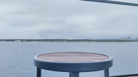 A-beer-bottle-on-table-holding-by-a-person-video-with-sea-in-the-background-|-Heineken-beer-bottle-on-table-video-background-in-4K