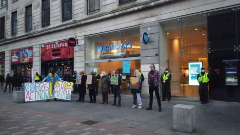 Climate-change-protesters-lining-up-outside-a-British-bank