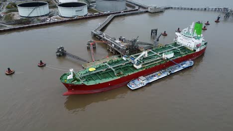 Silver-Rotterdam-chemical-oil-tanker-ship-loading-at-Tranmere-terminal-Liverpool-aerial-view-tracking-orbit-right
