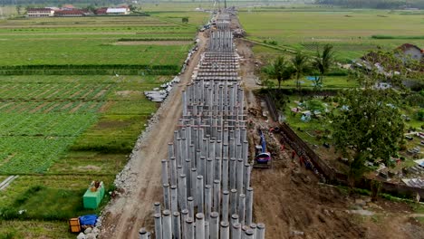Pylons-for-monorail-road-construction-in-Kulon-Progo-rural-area,-Yogyakarta-in-Indonesia