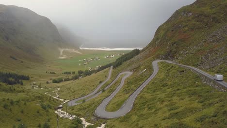 Grey-van-driving-down-the-road-to-hoddevik,-Norway
