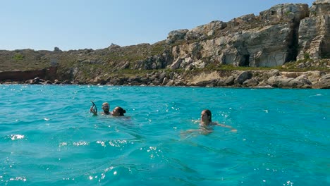 Girl-diving-in-turquoise-sea-water-of-Cala-Rossa-cove-at-Favignana-island-in-Sicily