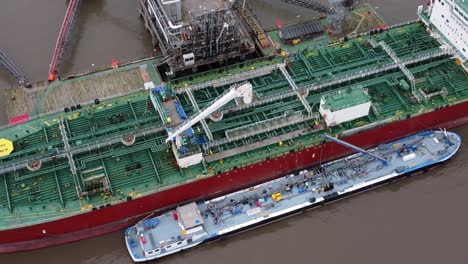 Silver-Rotterdam-oil-petrochemical-shipping-tanker-loading-at-Tranmere-terminal-Liverpool-aerial-view-closeup-Birdeye