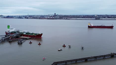 Silver-Rotterdam-oil-petrochemical-shipping-tanker-loading-at-Tranmere-terminal-Liverpool-aerial-slow-pan-view