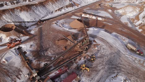 Birdseye-View-Of-Open-Pit-Mining,-Quarry-Mining-Equipment---Dolly-In-Shot