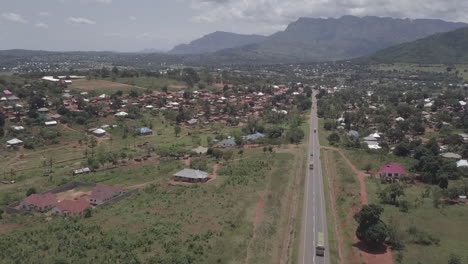 Aerial:-Misty-green-African-mountain-plateau-town-with-highway-traffic
