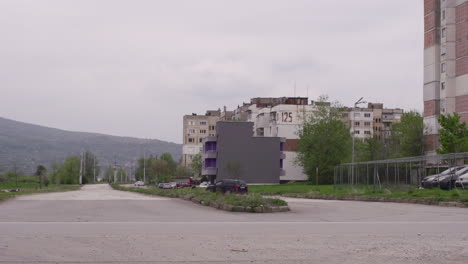 Old,-brutalist-apartment-buildings-next-to-a-road-in-post-communist-Bulgaria-in-Eastern-Europe