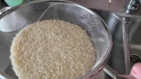 shaking-white-rice-in-the-kitchen
