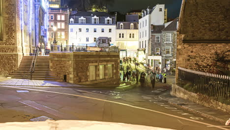 View-of-the-streets-of-a-town-on-Guernsey-Island-in-the-English-Channel-off-the-coast-of-Normandy,-part-of-the-Bailiwick-of-Guernsey-in-timelapse-with-heavy-traffic-and-huge-gathering-of-people-2013