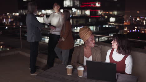Business-people,-talking-and-night-on-rooftop