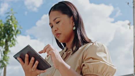 Asian,-businesswoman-and-thinking-on-tablet