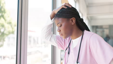 Doctor,-woman-and-burnout-by-window-with-stress