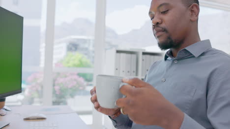 Black-man-drinking-coffee-in-office