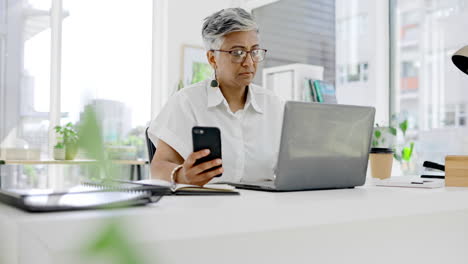 Business-woman,-phone-and-laptop-at-desk-in-office