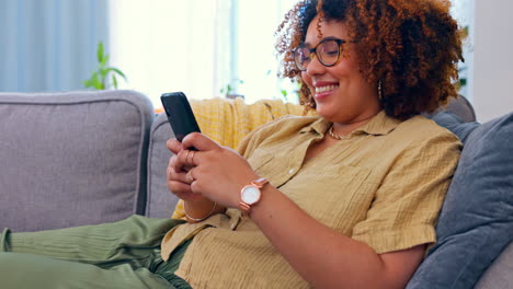 Phone,-laughing-and-black-woman-on-a-sofa