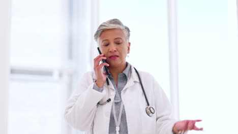 Mature,-doctor-and-phone-call-in-hospital