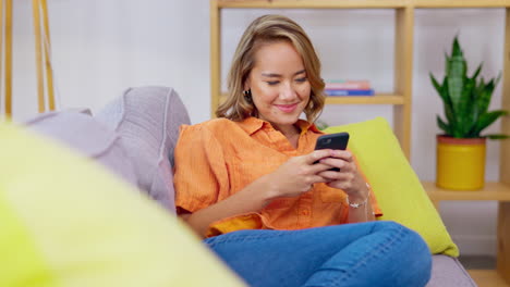 Smile,-texting-and-phone-with-woman-on-sofa