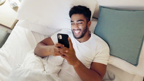 Happy-man,-phone-and-bed-above-in-morning-social