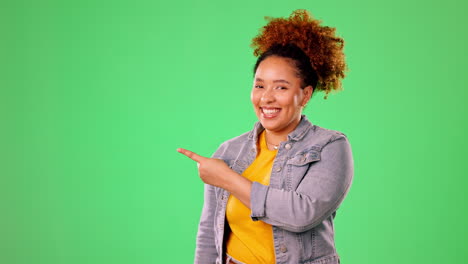 Happy-woman-pointing-to-green-screen-isolated