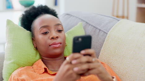 Relax,-phone-and-black-woman-lying-on-sofa