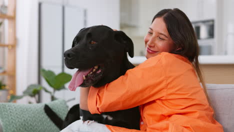 Woman-petting-dog-on-sofa,-love