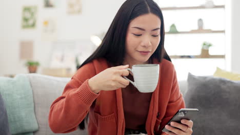 Coffee,-phone-and-Asian-woman-on-a-sofa-browsing
