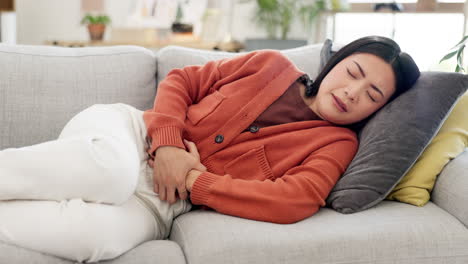 Pain,-cramps-and-Asian-woman-on-couch