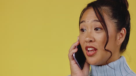 Phone-call,-happy-and-Asian-woman-in-a-studio