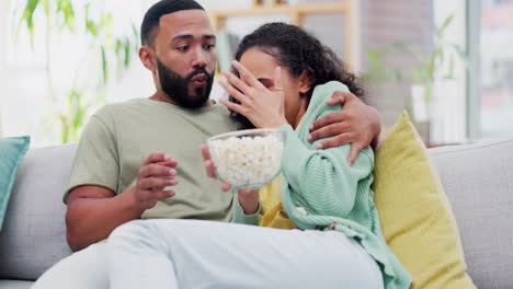 Couple,-sofa-and-popcorn,-television-with-horror