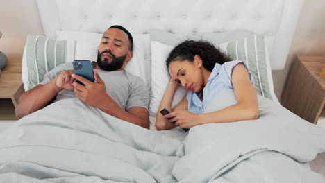 Man,-woman-and-bored-in-bed-with-phone-in-home