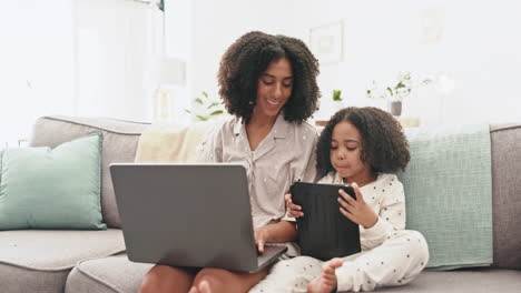 Laptop,-tablet-and-mom-with-child-on-sofa-together