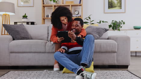 Black-couple,-tablet-and-hug-on-living-room-sofa