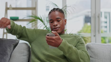 Black-man,-phone-and-smile-relaxing-on-sofa