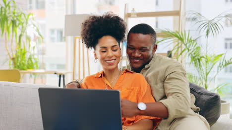 Couple,-laptop-and-smile-with-hug-in-home-living