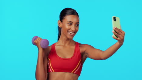 Fitness,-woman-and-dumbbell-in-studio-for-selfie