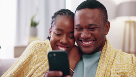 Laugh,-phone-and-black-couple-on-sofa-in-home