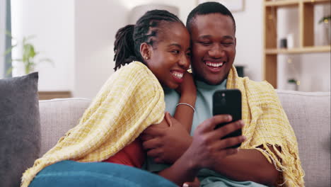 Relax,-phone-and-black-couple-laugh-on-sofa