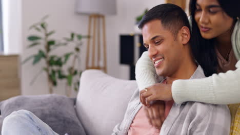Phone,-surprise-and-hug-with-couple-in-living-room